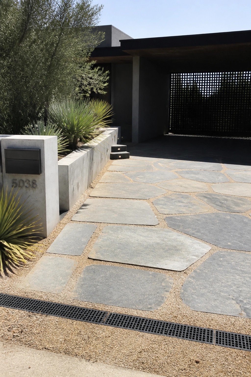 Modern home entrance with flagstone path, concrete mailbox 5038, and desert plants.