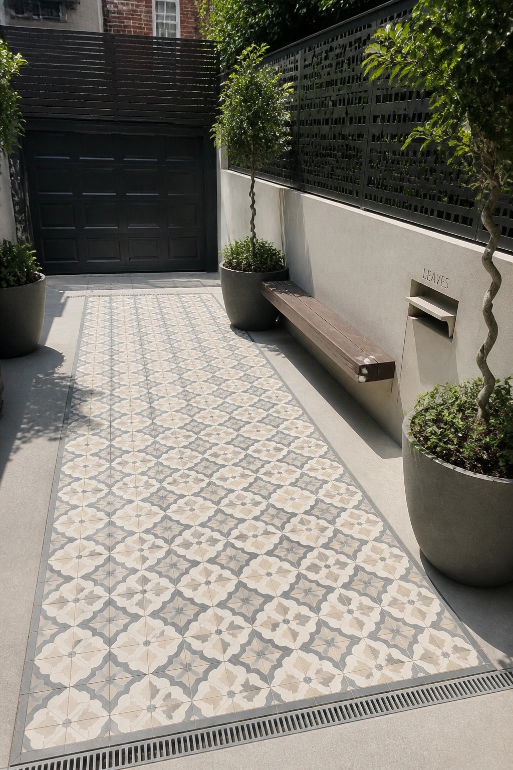 Courtyard walkway with ornate patterned tiles, wooden bench, potted plants and garage