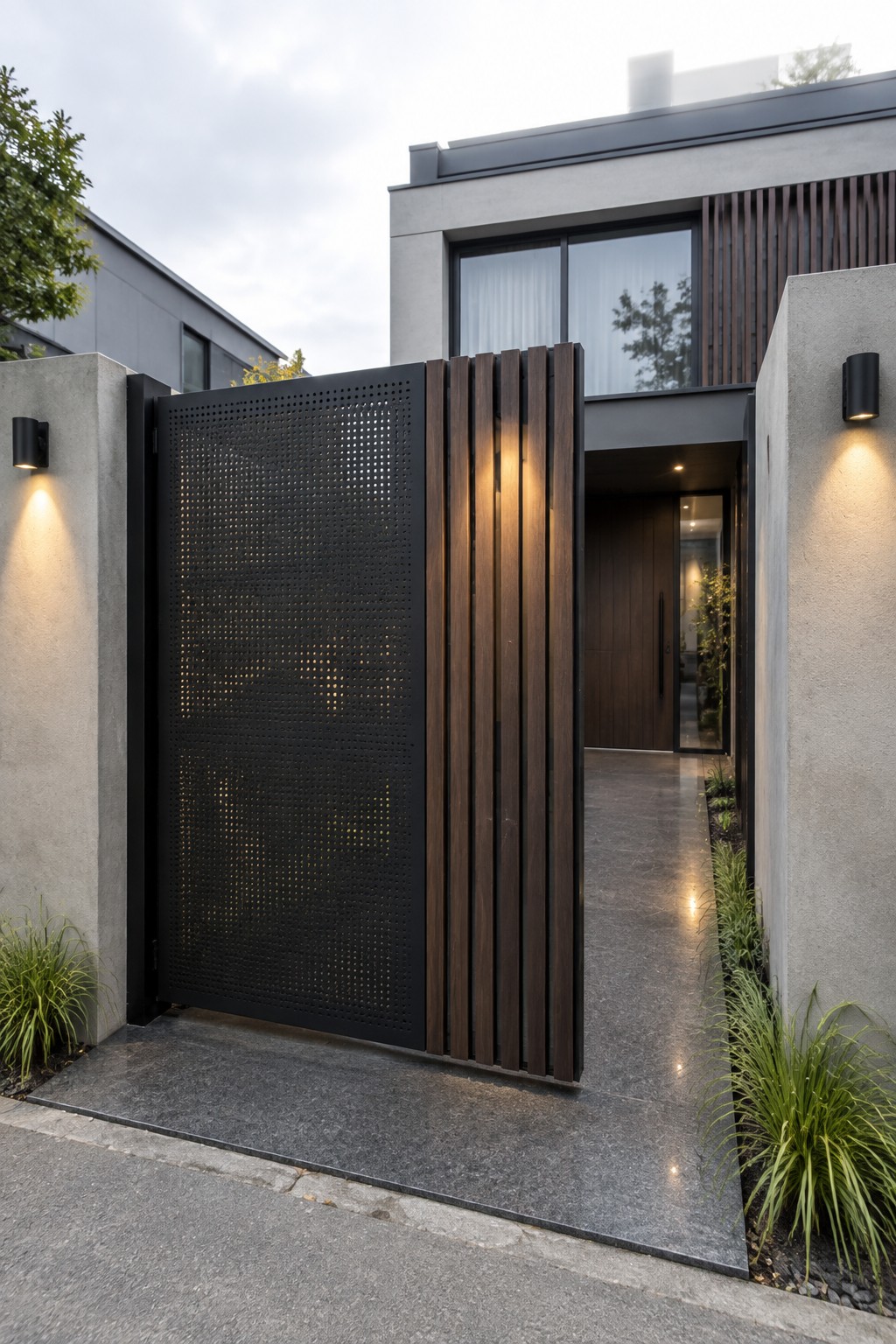 Modern entrance with open black perforated gate, wooden slats, and lit concrete walls.