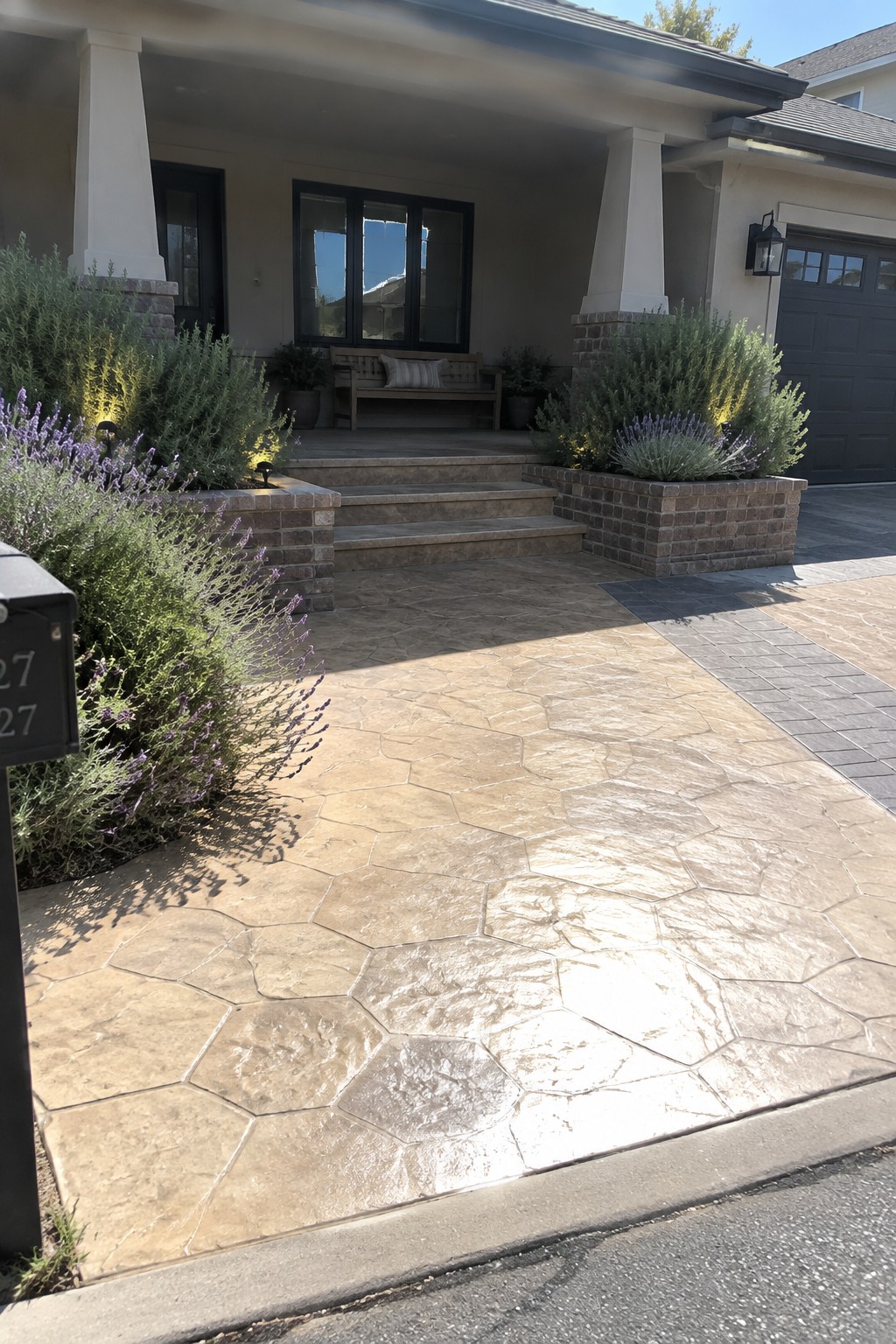 Modern house entrance with stone steps, hexagonal pavers, brick planters, and lavender.